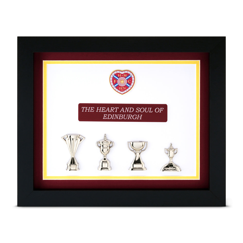 Framed display with trophies and a heart-shaped emblem on a white background